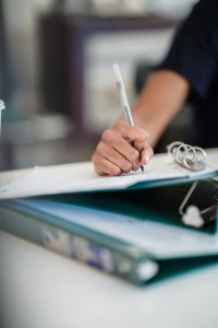 Reviewing Property Documents and Lease Agreements Focused image of a businesswoman writing notes in a professional office setting